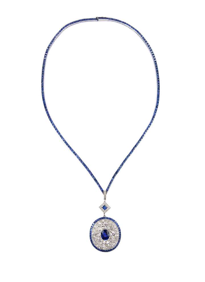 Early 20th century sapphire and diamond cluster pendant and sapphire line necklace, c.1915, the oval pendant centred by a cushion cut Burma sapphire,